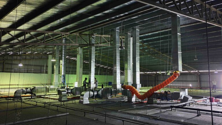 Multiple exhaust and fresh air ductings installed vertically from the top of cleanroom towards the rooftop of factory.