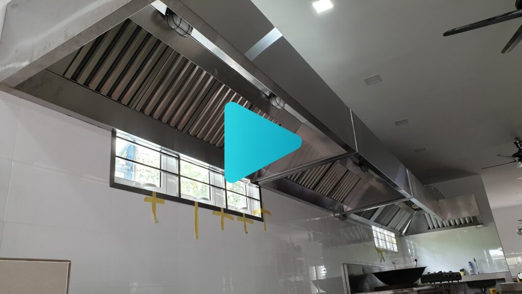 A professional restaurant kitchen featuring a custom CrystalAir stainless steel exhaust hood and ducting system.