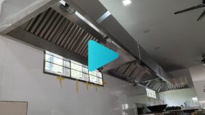 A professional restaurant kitchen featuring a custom CrystalAir stainless steel exhaust hood and ducting system.