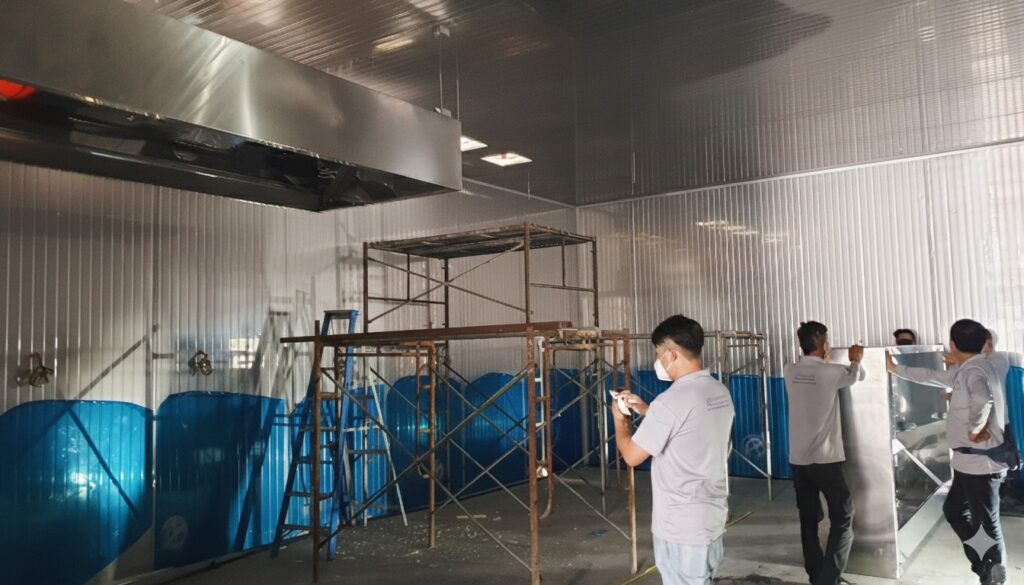 CrystalAir technical team installing an industrial exhaust system inside a PU panel production room in Klang.