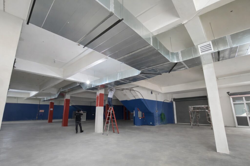 industrial air cooler ducting system with discharge grille inside factory