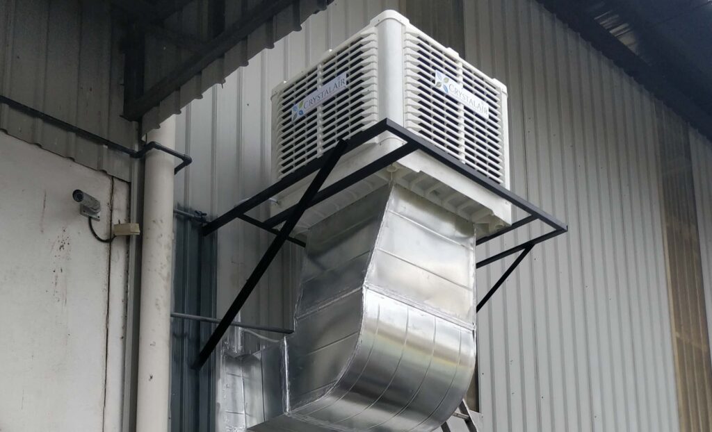 Wall-mounted industrial air cooler connected to galvanized ducting system installed at factory in Malaysia