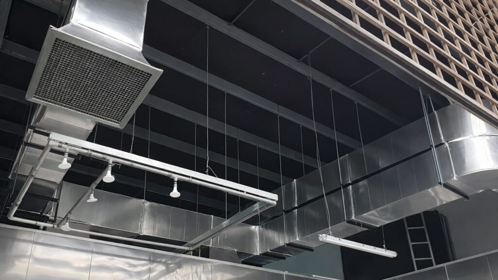 Industrial stainless steel exhaust ducting and ventilation system inside factory building