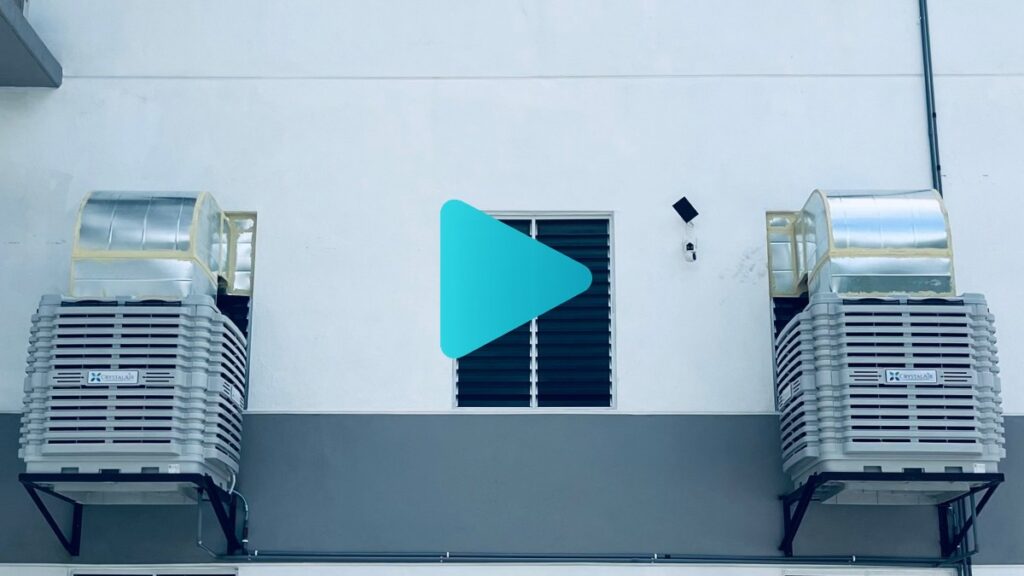 CrystalAir evaporative air coolers installed on the exterior wall of a large manufacturing factory in Malaysia.