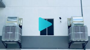CrystalAir evaporative air coolers installed on the exterior wall of a large manufacturing factory in Malaysia.