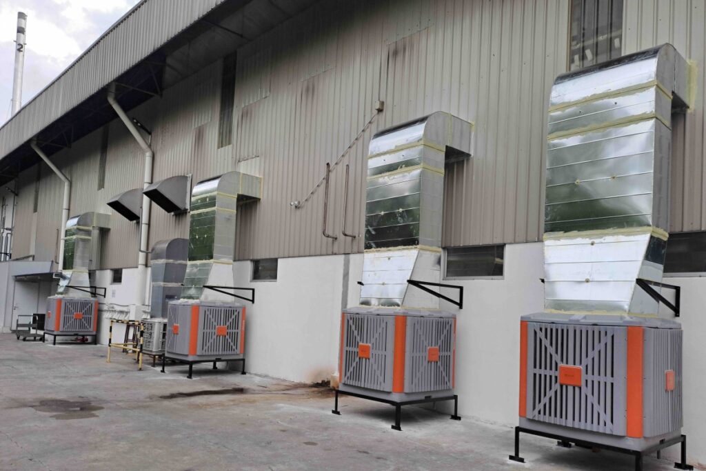 Four CrystalAir AC-500 evaporative air coolers installed outside an instant noodle factory production floor in Malaysia.