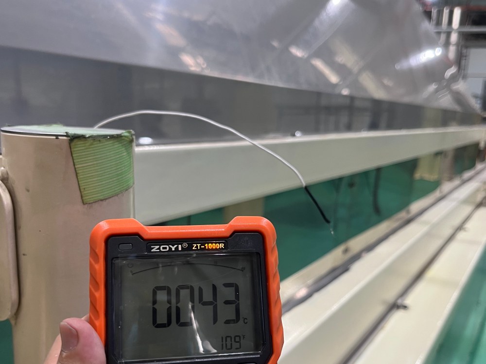 Temperature meter showing 43°C before evaporative air cooler installation at an instant noodle factory production floor.