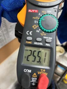 Multimeter showing 255.1V during kitchen exhaust fan electrical troubleshooting