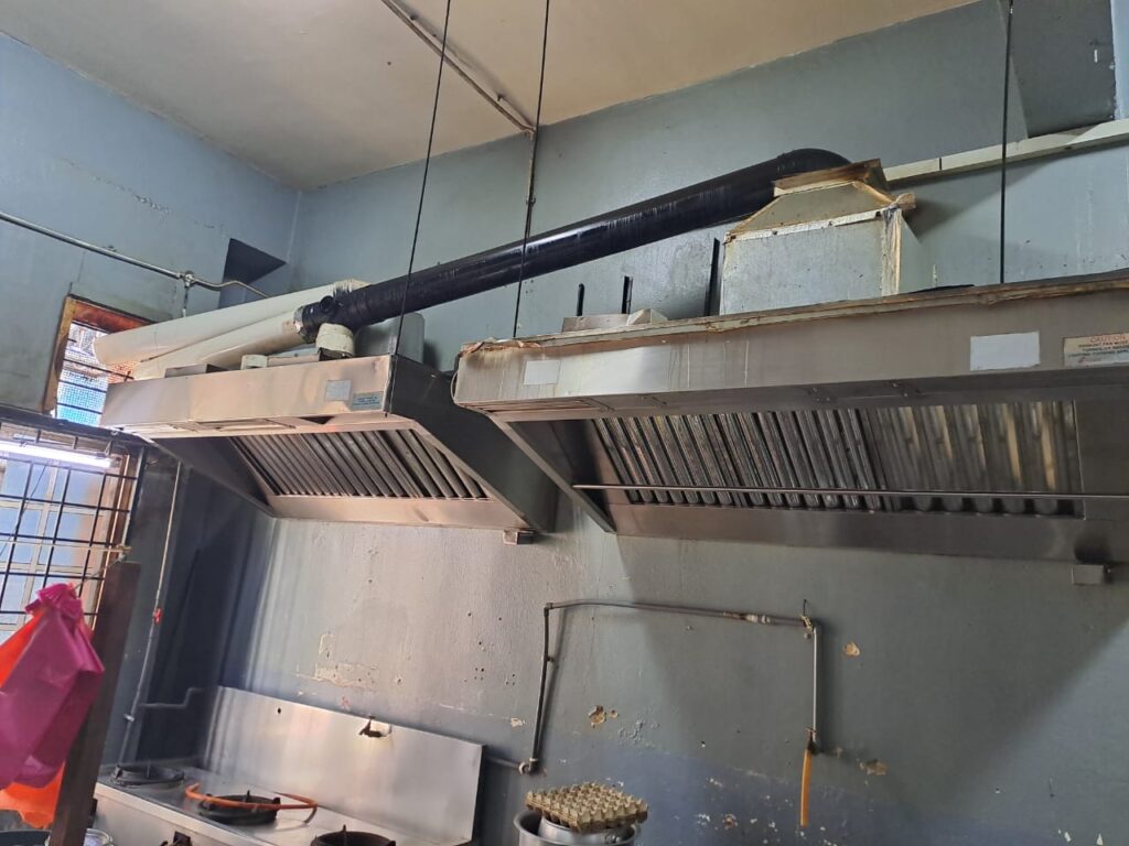Existing restaurant kitchen exhaust hood installation with no fan motor and improper PVC pipe ducting