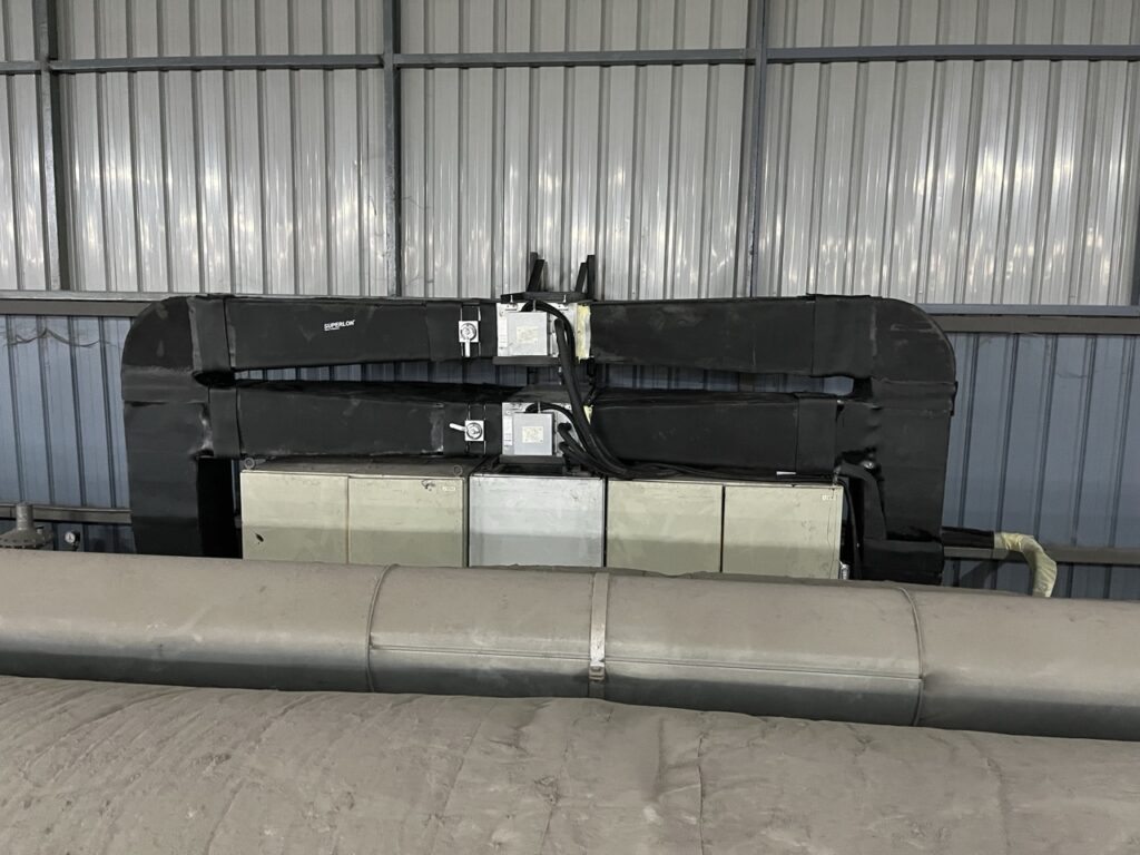 Two 1.5 HP ducted air conditioners installed for 24-hour factory machine control panel cooling.