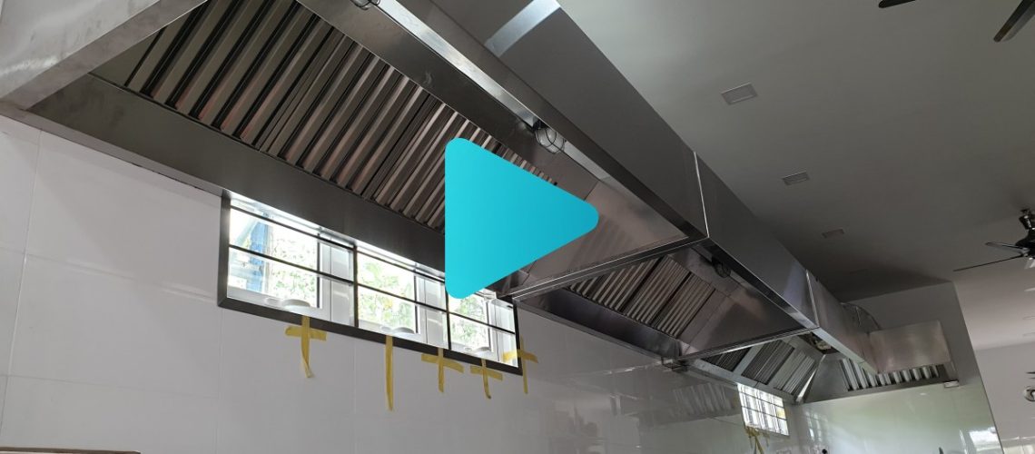 A professional restaurant kitchen featuring a custom CrystalAir stainless steel exhaust hood and ducting system.