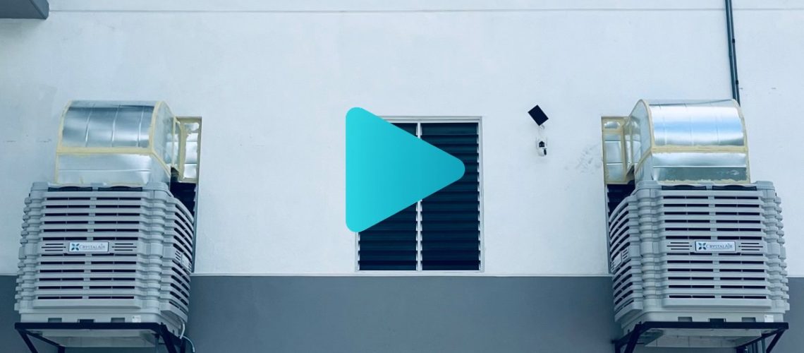 CrystalAir evaporative air coolers installed on the exterior wall of a large manufacturing factory in Malaysia.