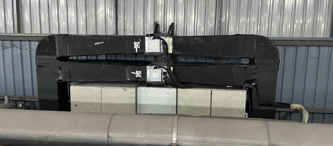 Two 1.5 HP ducted air conditioners installed for 24-hour factory machine control panel cooling.