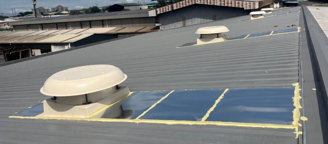 Rooftop exhaust fans installed on a metal fabrication factory roof for high-level hot air extraction.