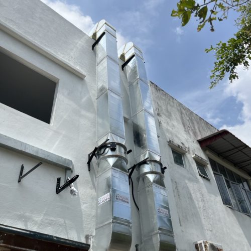 Restaurant kitchen exhaust ducting routed vertically to rooftop discharge for two standalone hood systems.
